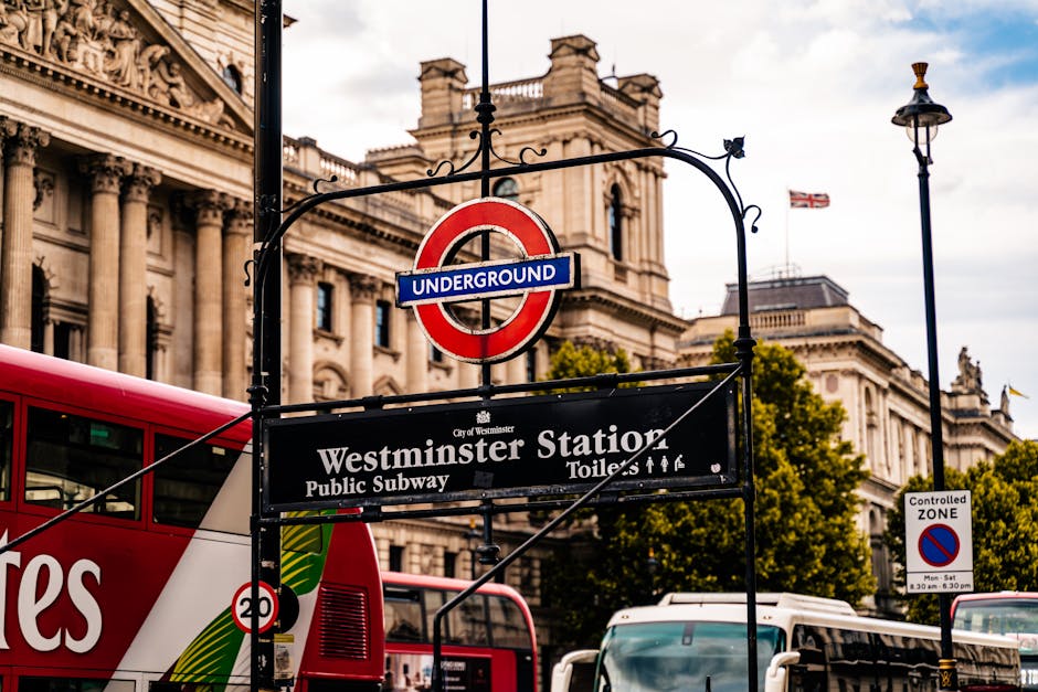 A street scene in Westminster with a red and black London bus displaying route number 46 heading towards Paddington, parked adjacent to the curb with its front facing the viewer. To the left, a white 